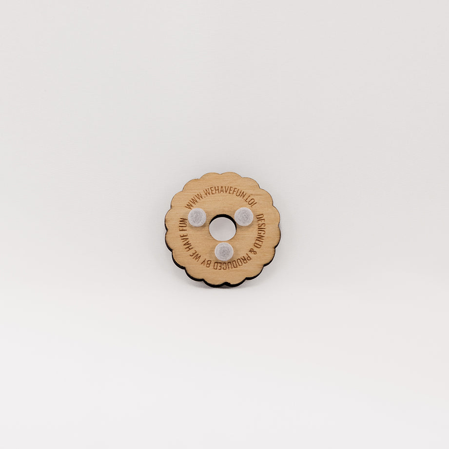 The back of the round planchette with a scalloped edge and 3 felt pads to ensure smooth sliding. The words "Designed & produced by we have fun www.wehavefun.lol" are engraved on the back.
