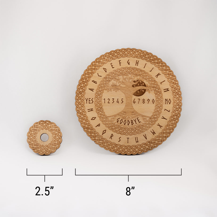 Image of the die-cut spirit board and the circular planchette with a ruler at the bottom with measurements of 2.5" for the round planchette, and 8" for the round spirit board.