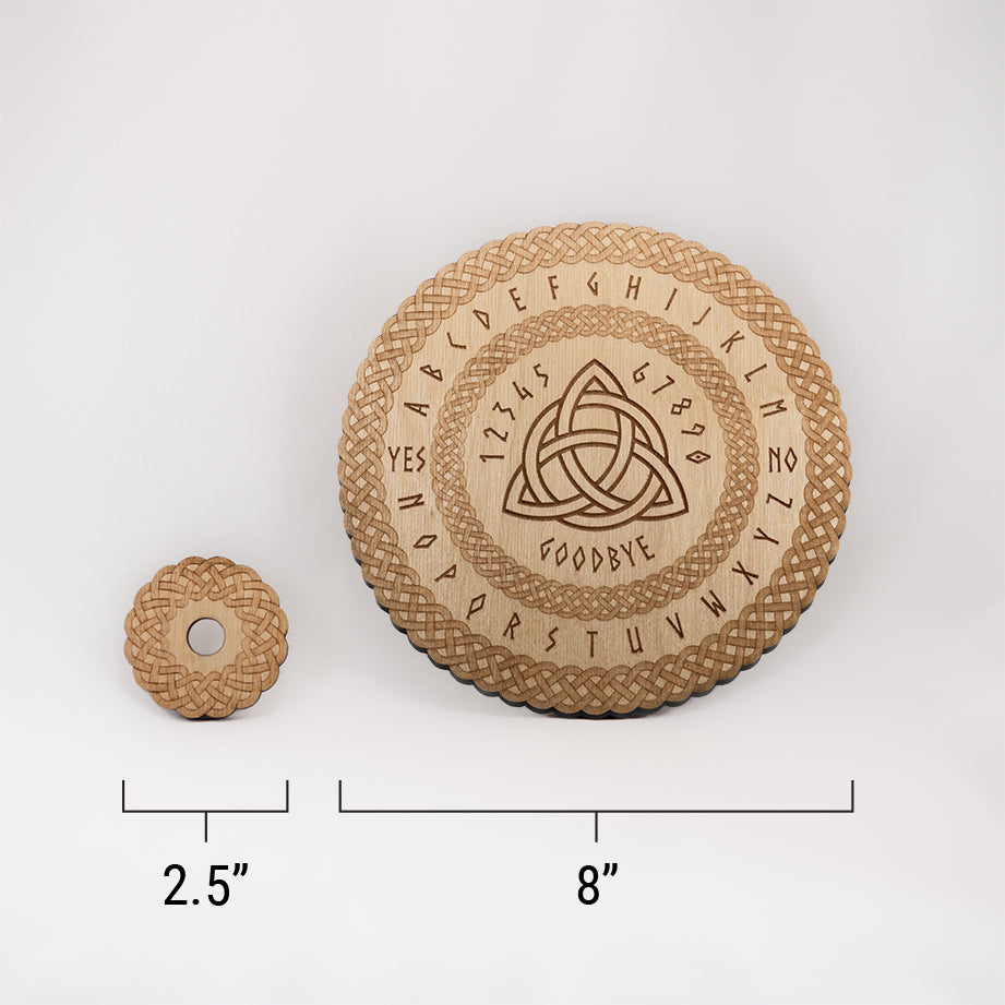 Image of the die-cut spirit board and the circular planchette with a ruler at the bottom with measurements of 2.5" for the round planchette, and 8" for the round spirit board.