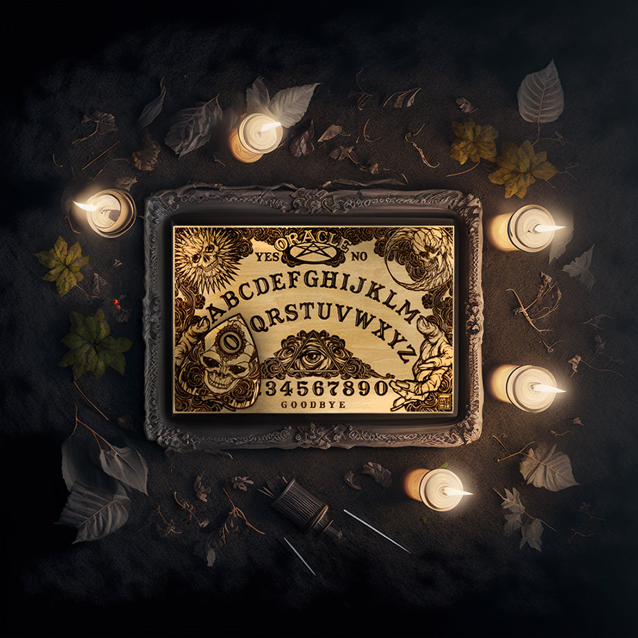 A rectangular wooden laser-cut spirit board engraved with the alphabet and numbers 0-9, yes, no, and goodbye. A sun with a skull face is engraved in the top left corner, a moon with a skull face is engraved in the top right corner, the bottom left and right corners are decorated with outstretched hands. A planchette engraved with a skull is placed on top of the board. The spirit board is sitting in a frame on the ground surrounded by leaves and lit candles.