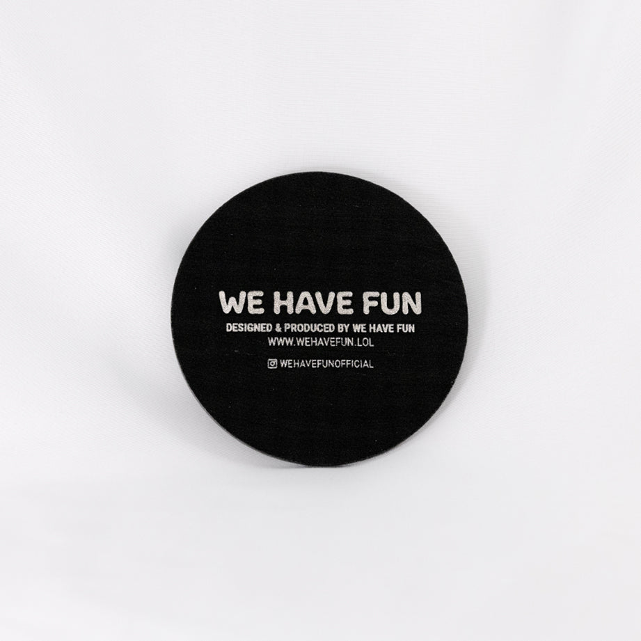 Back of the coaster engraved with "We Have Fun" logo, "Designed and produced by We Have Fun", "www.wehavefun.lol", and instagram bio link "wehavefunofficial".