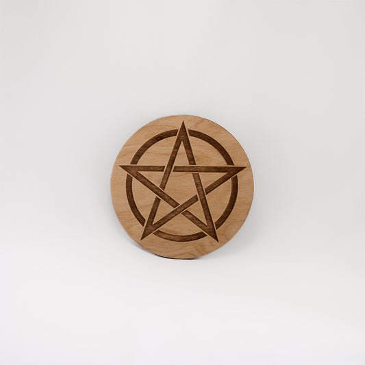 A circular wooden laser-cut crystal grid engraved with a Pentacle with a plain white background.
