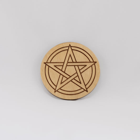 A circular wooden laser-cut crystal grid engraved with a Pentacle with a plain white background. 